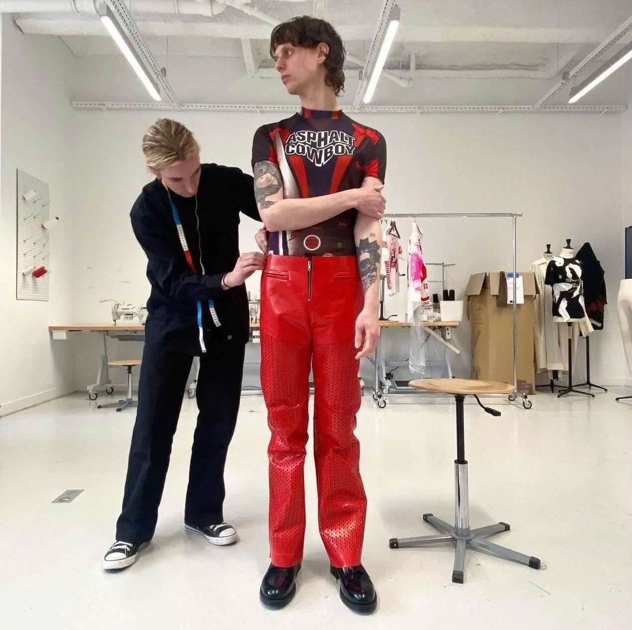 Logan working with a fashion model on his collection.
